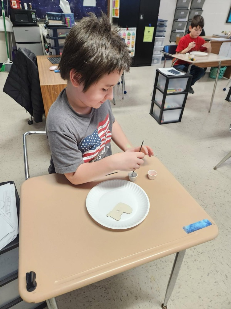 student painting ornament