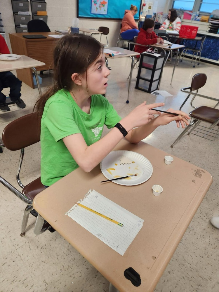 student painting ornament