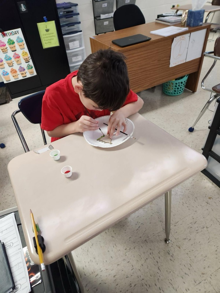 student painting ornament