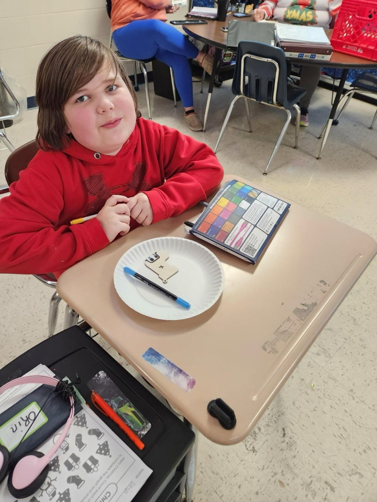 student painting ornament