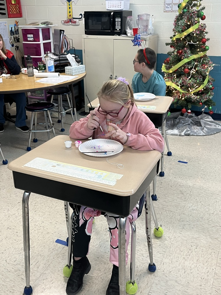 student painting ornament