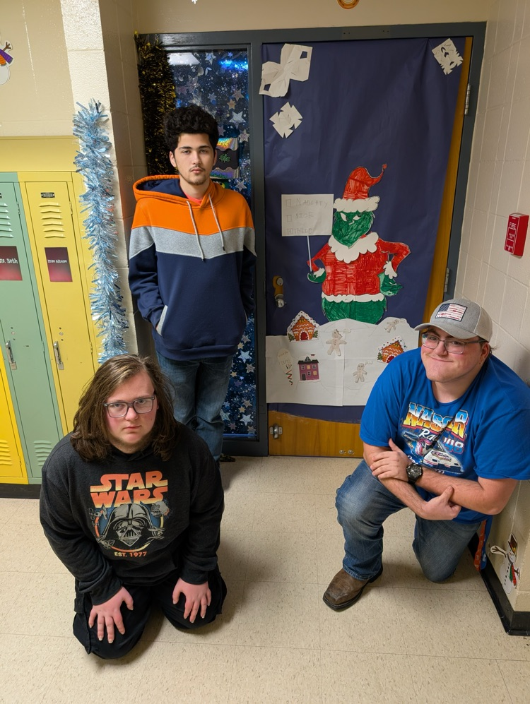 boys in front of Christmas themed door