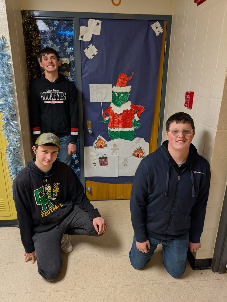 boys in front of Christmas themed door