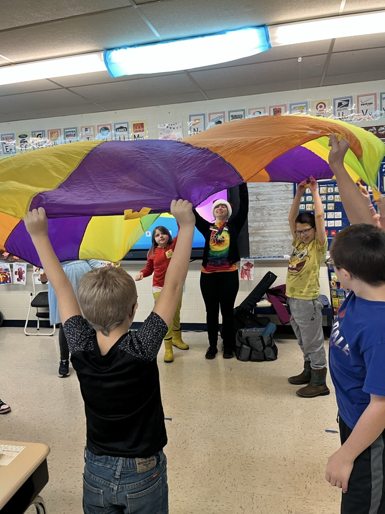 students playing with parachute