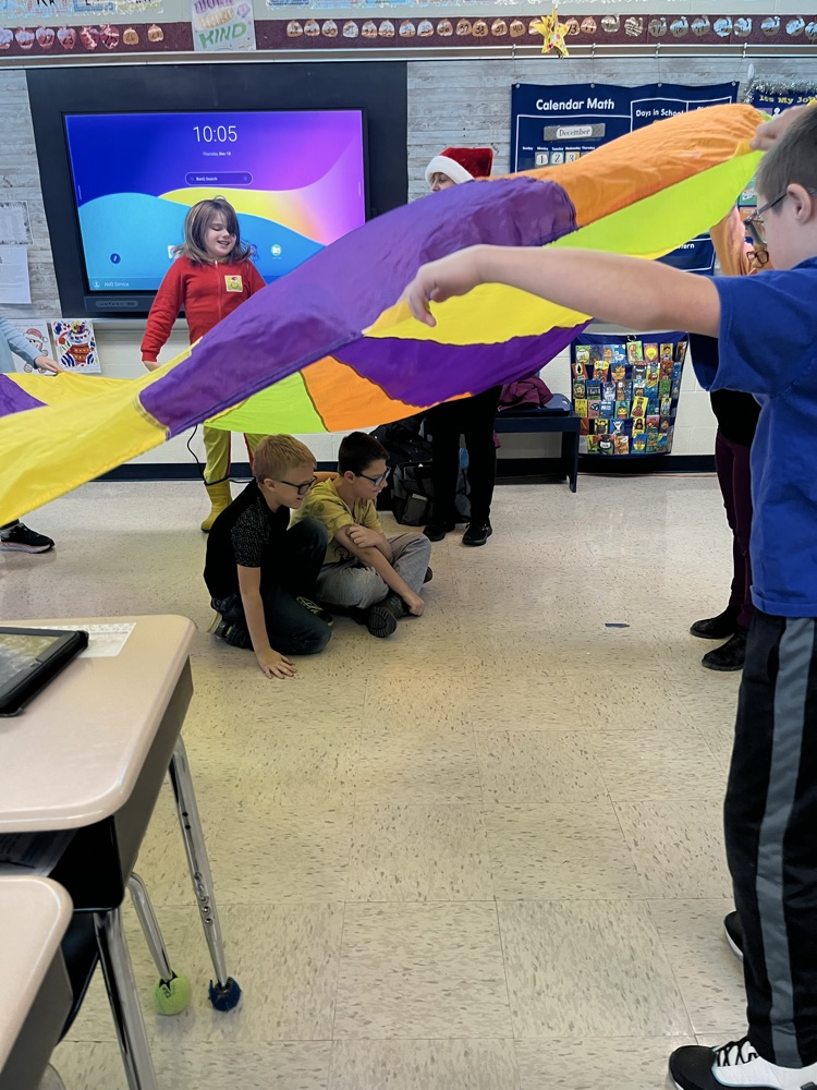 students playing with parachute