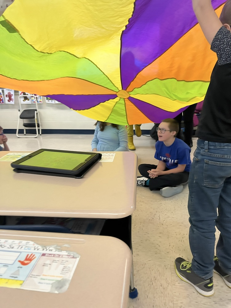 students playing with parachute