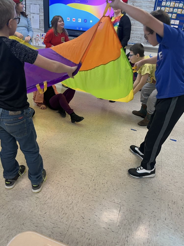 students playing with parachute