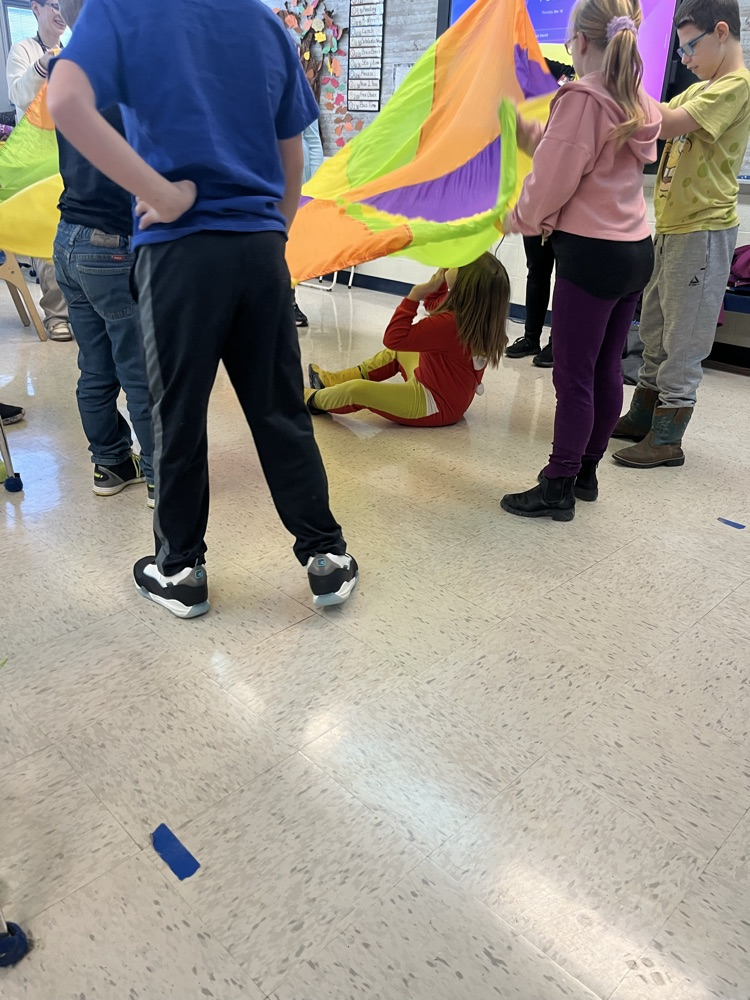 students playing with parachute