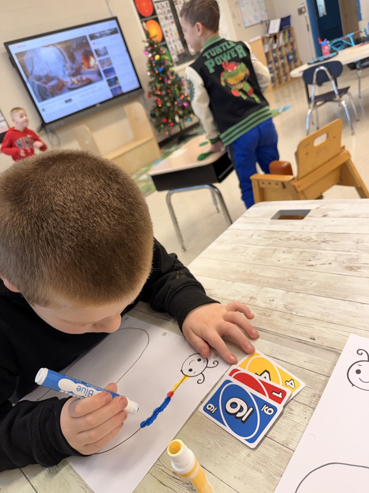 student using bingo markers to make caterpillar