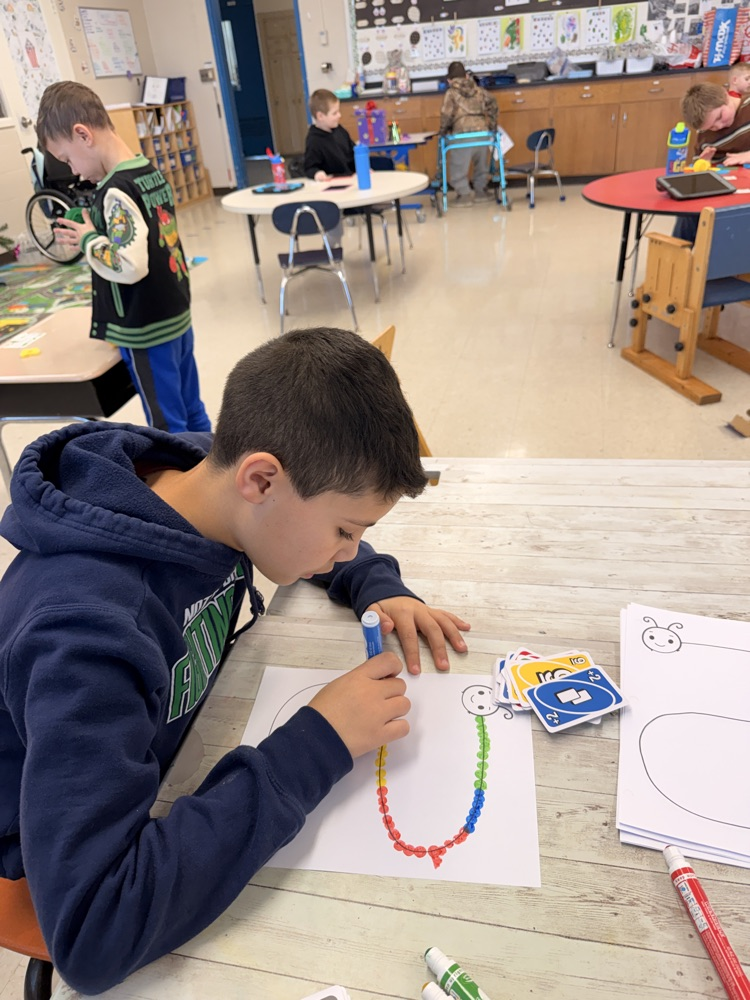 student using bingo markers to make caterpillar