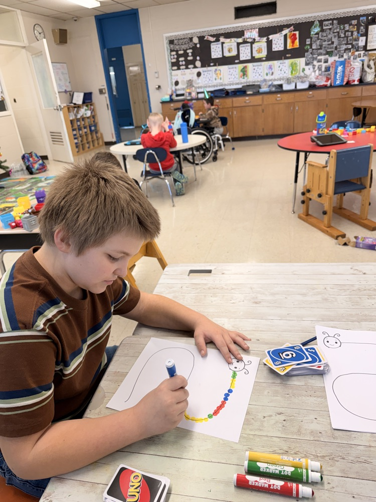 student using bingo markers to make caterpillar
