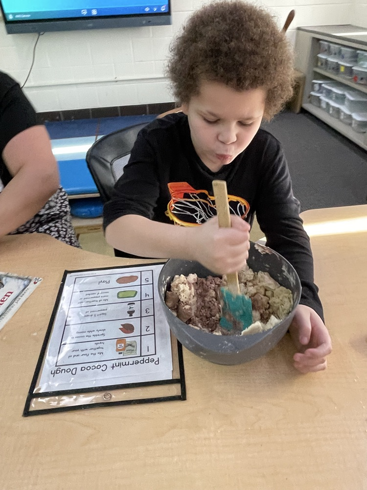 student mixing with a spatula