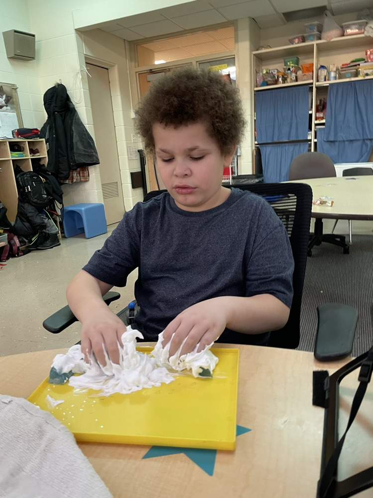 student playing in snow cream