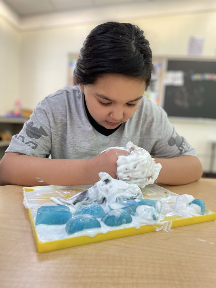 student playing in snow cream