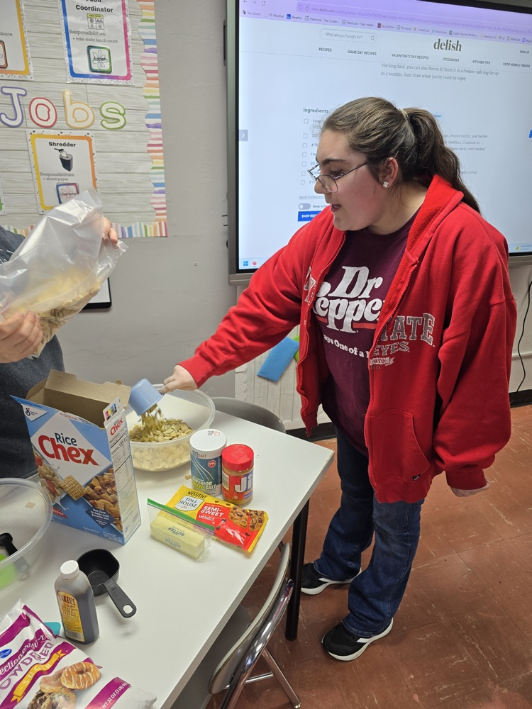 student measuring cereal