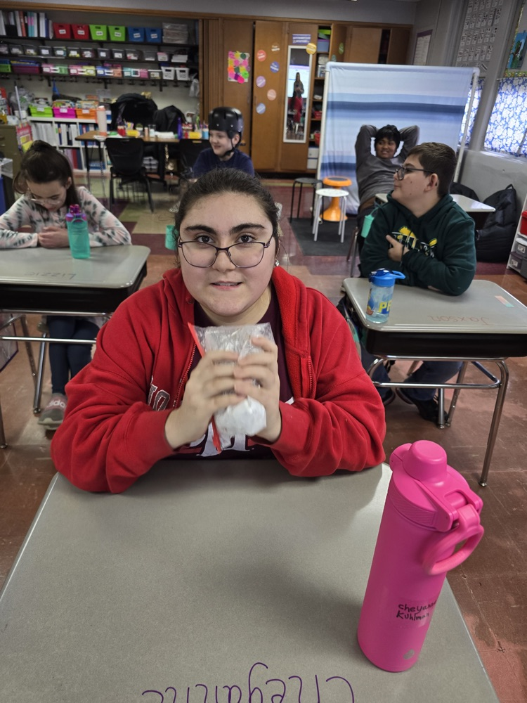 student shaking cereal in powdered sugar