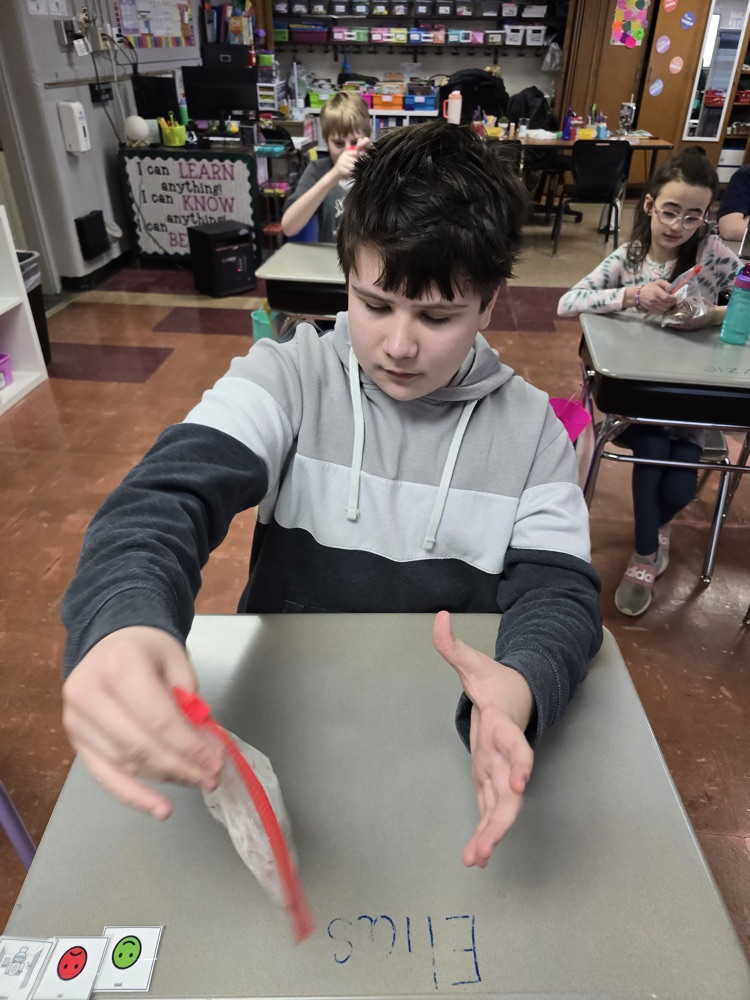 student shaking cereal in powdered sugar