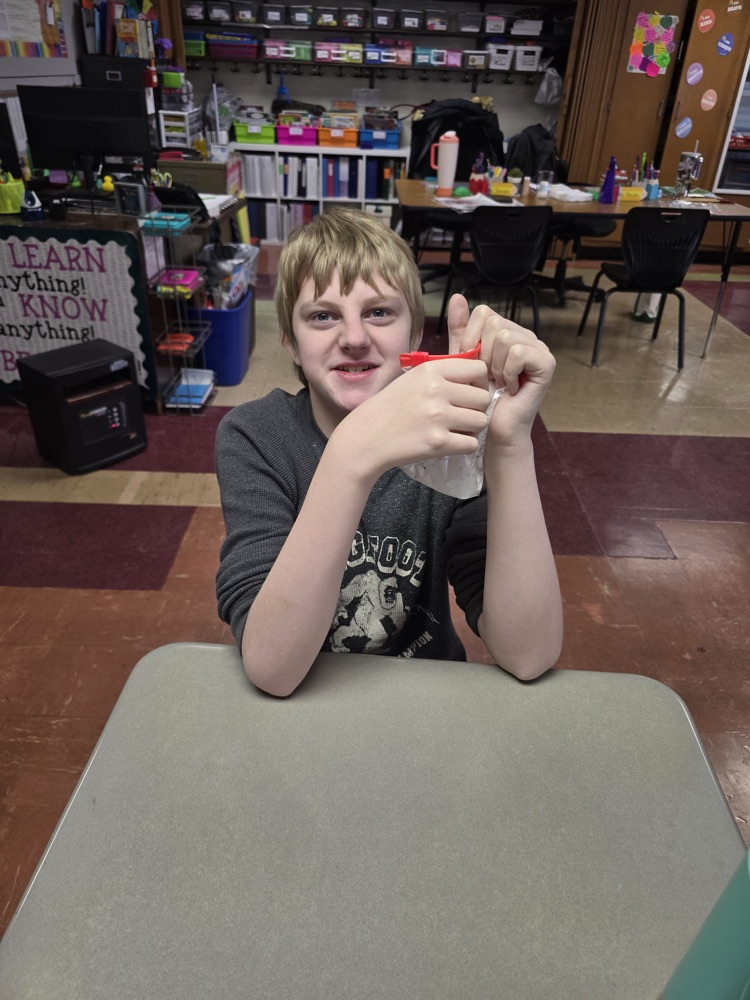 student shaking cereal in powdered sugar