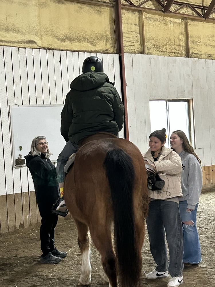 student riding horse