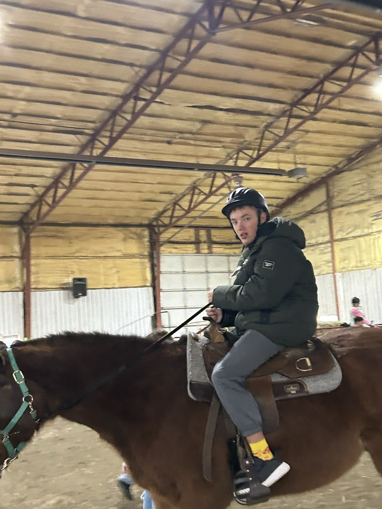 student riding horse