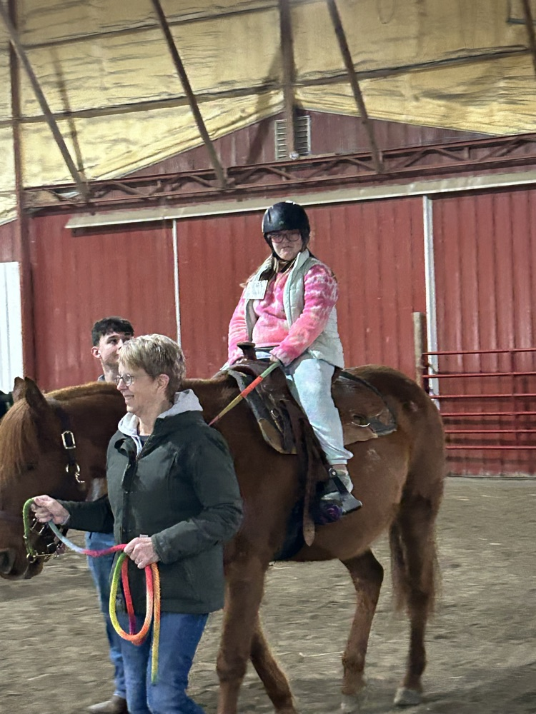 student riding horse