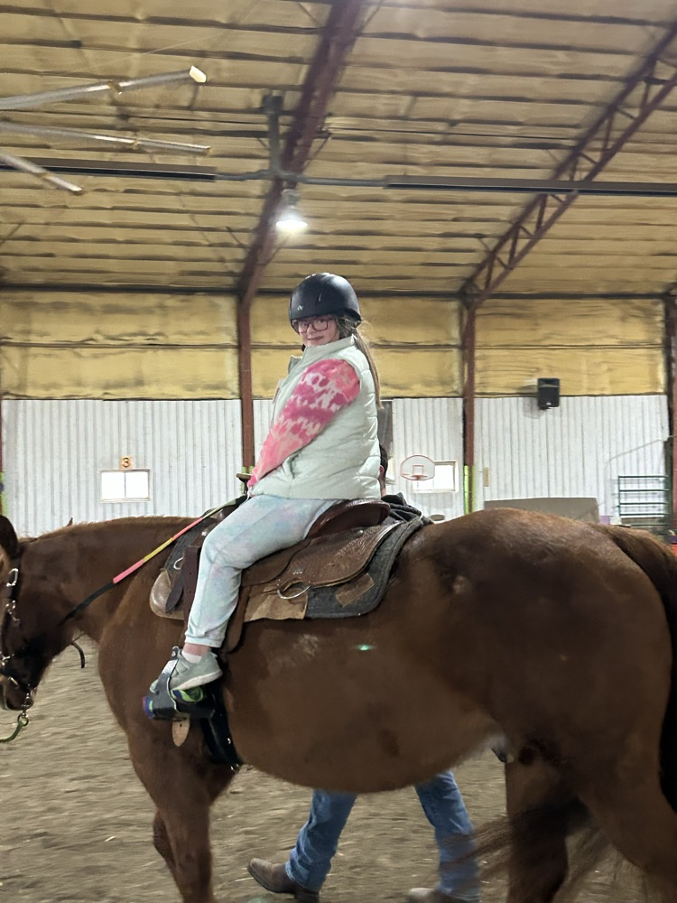 student riding horse