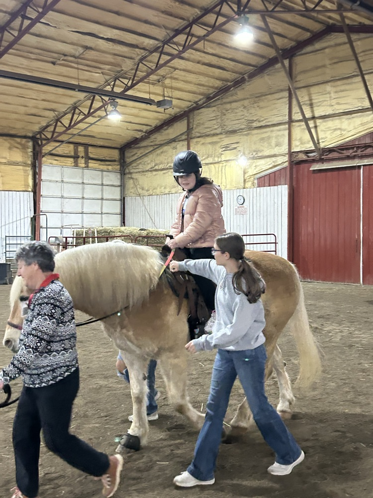 student riding horse