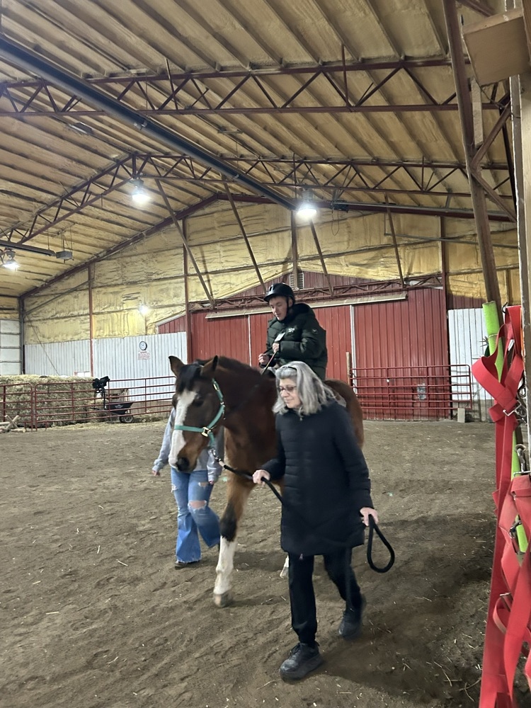 student riding horse