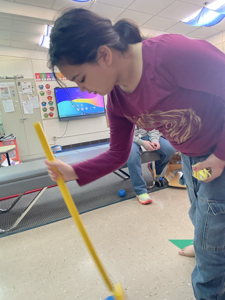 student holding hockey stick