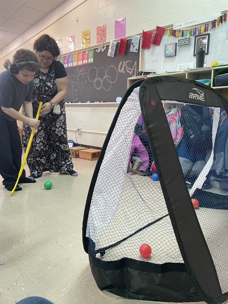 student holding hockey stick