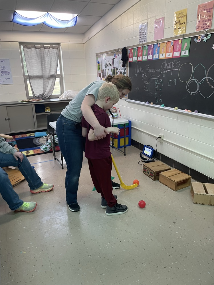 student holding hockey stick