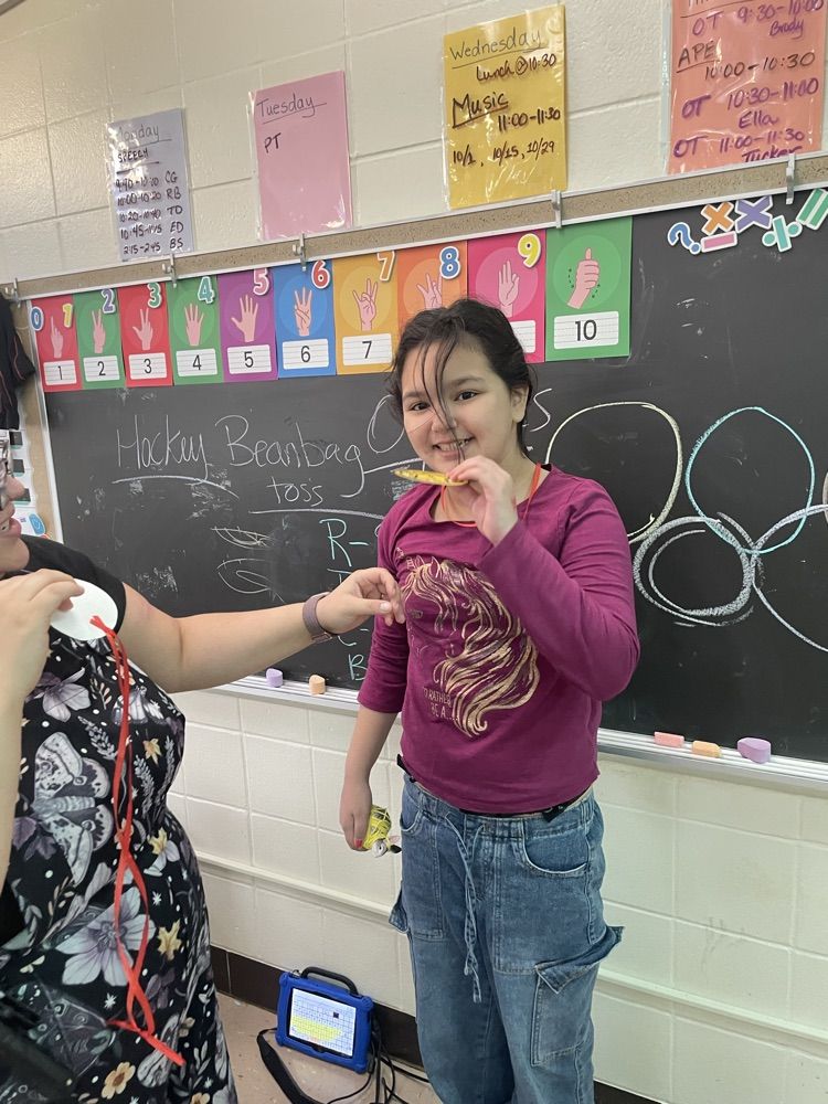 student holding medal