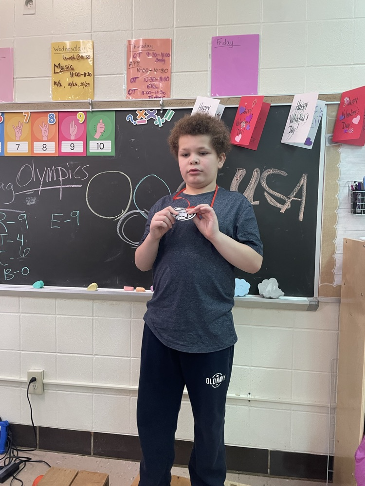 student holding medal