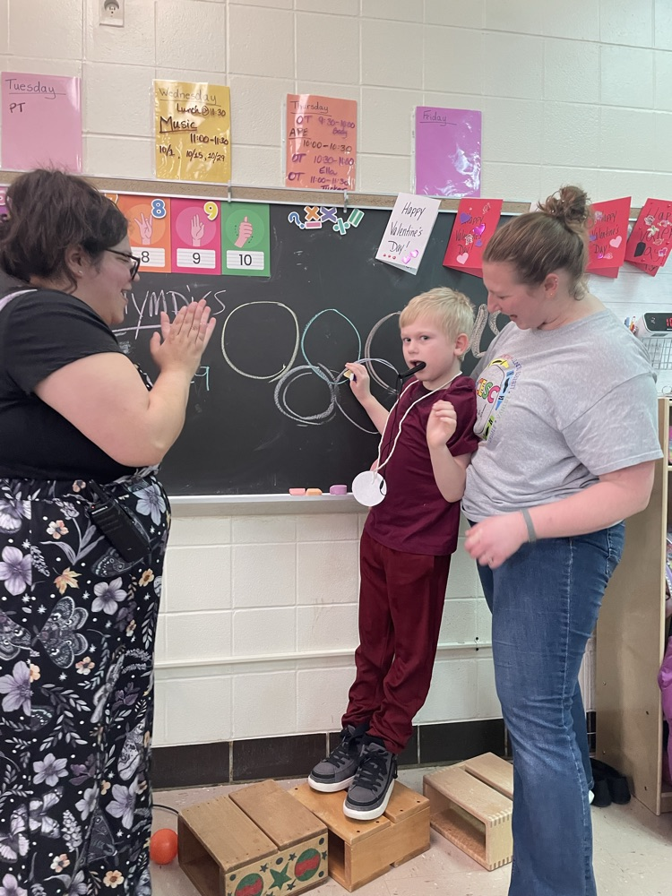 student holding medal