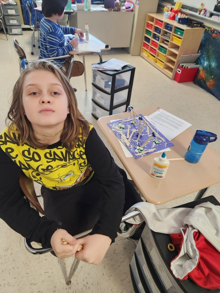 student building with popsicle sticks, glue, and clay