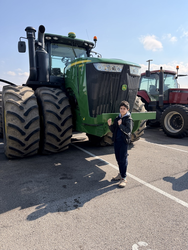 student in front of tractor