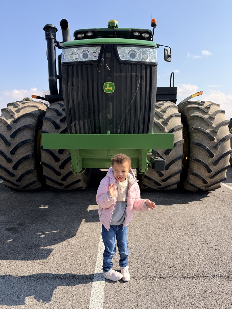student in front of tractor