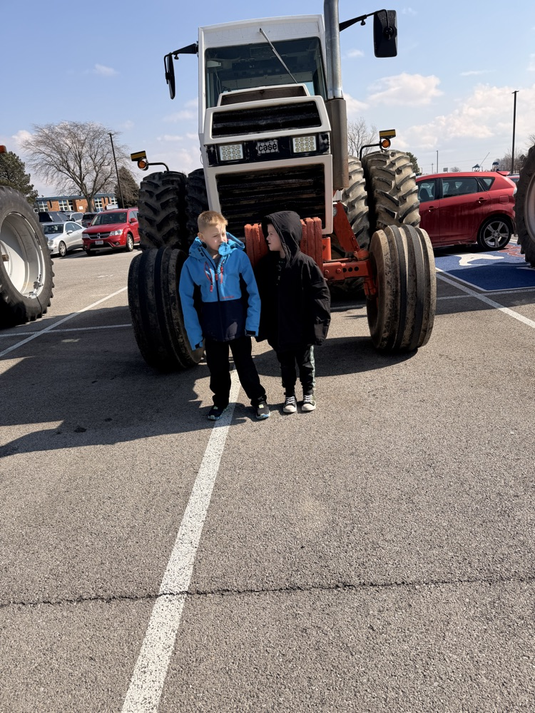 students in front of tractor