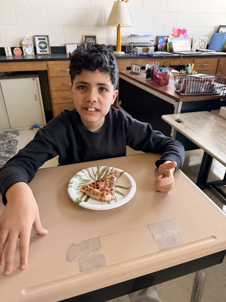 student eating pizza
