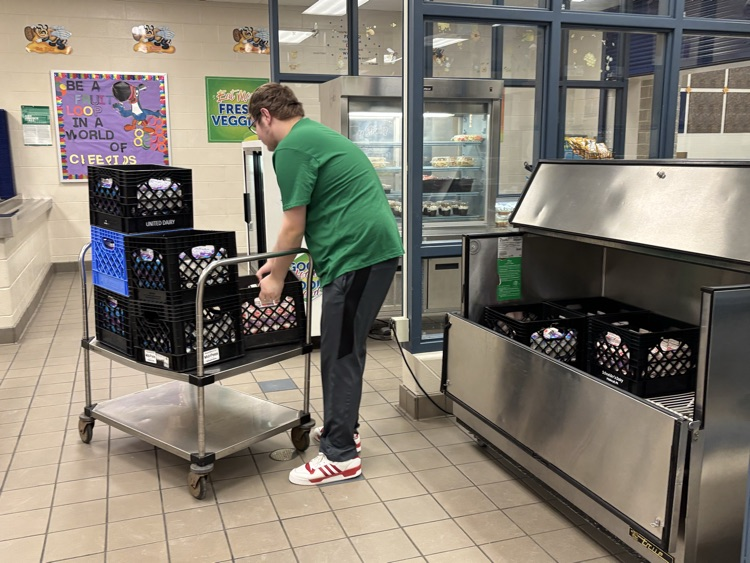 student unloading milk