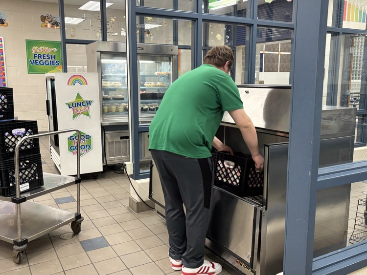student moving milk crates