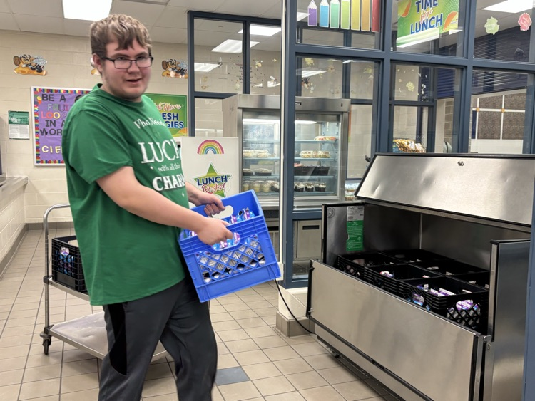 student lifting milk crate