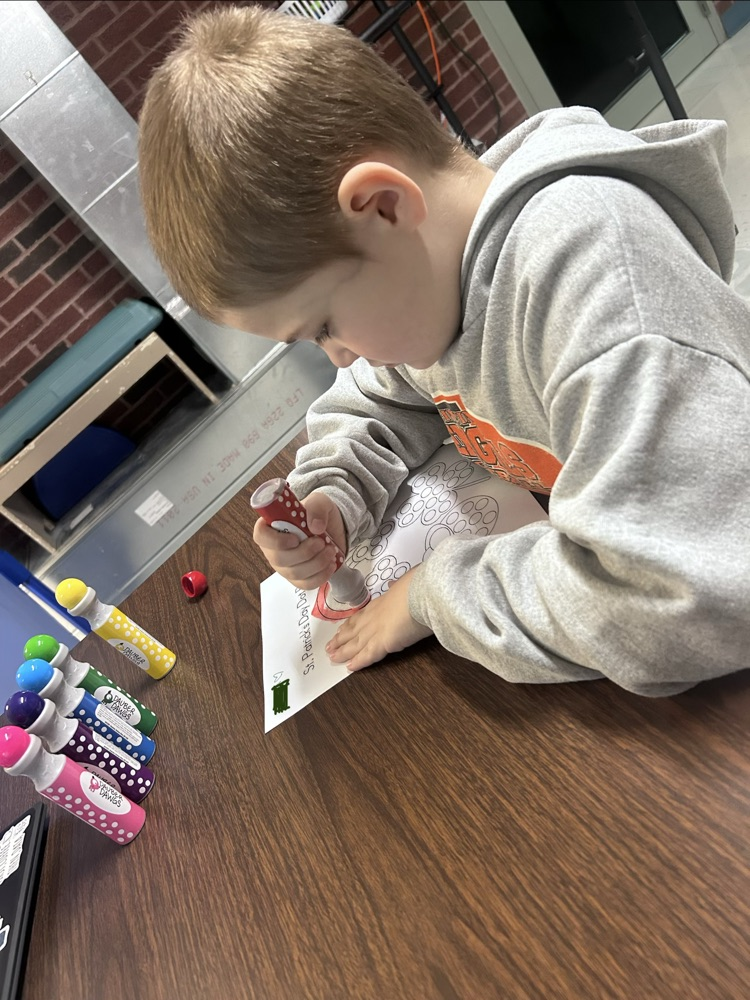 student using bingo stamper on Saint Patrick’s day worksheet