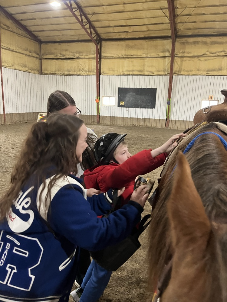 student getting on horse