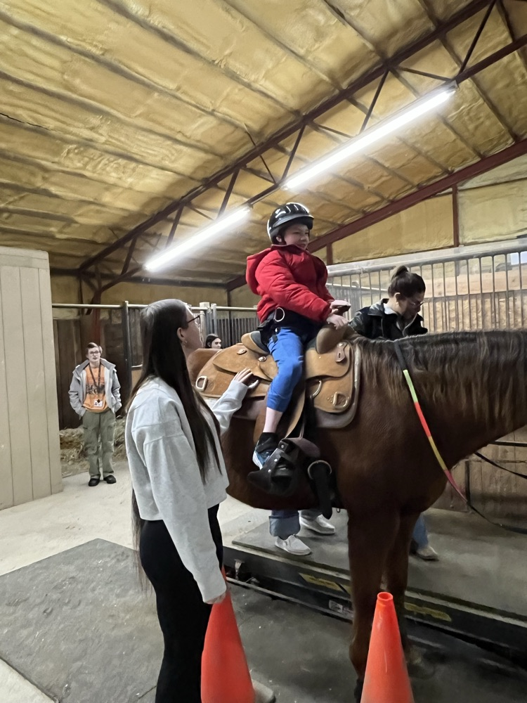 student sitting on horse