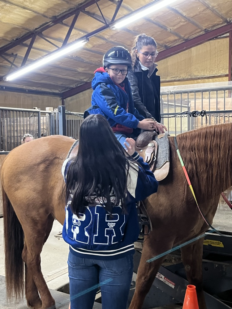 student sitting on horse