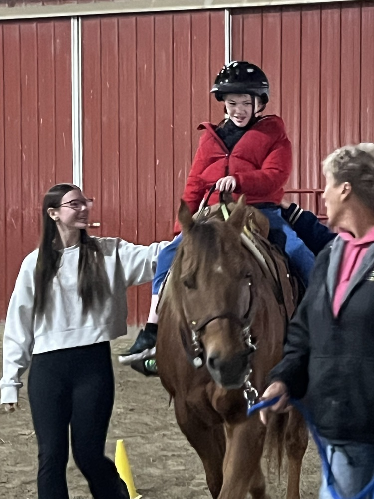 student sitting on horse