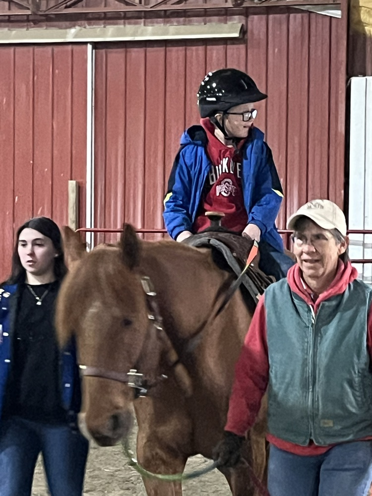 student sitting on horse