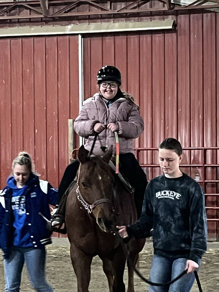 student sitting on horse