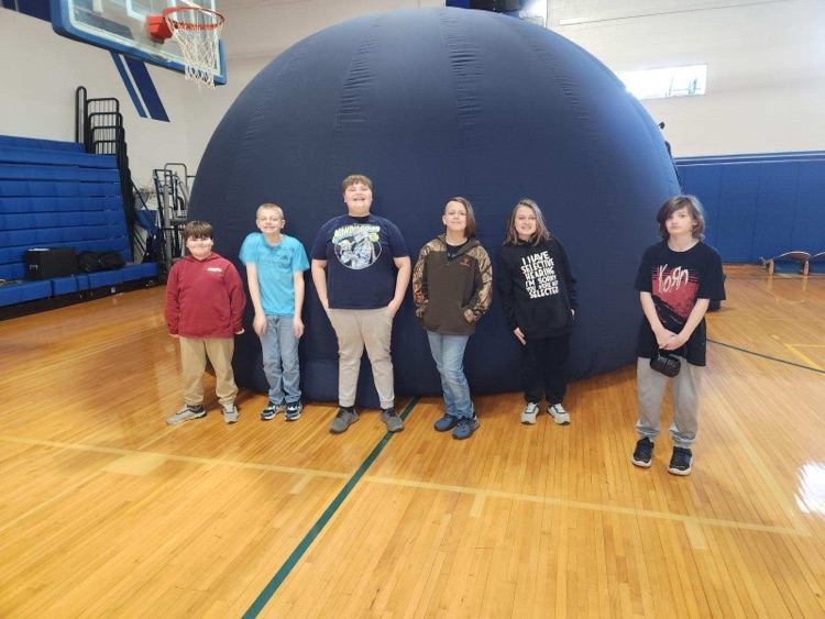 students outside of blow up planetarium